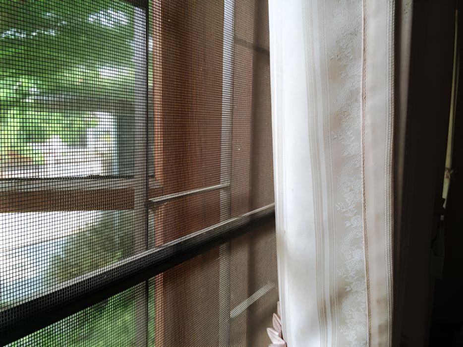 A Close Up of a Window With a Screen on It — Newcastle Curtains And Blinds In Wallsend, NSW