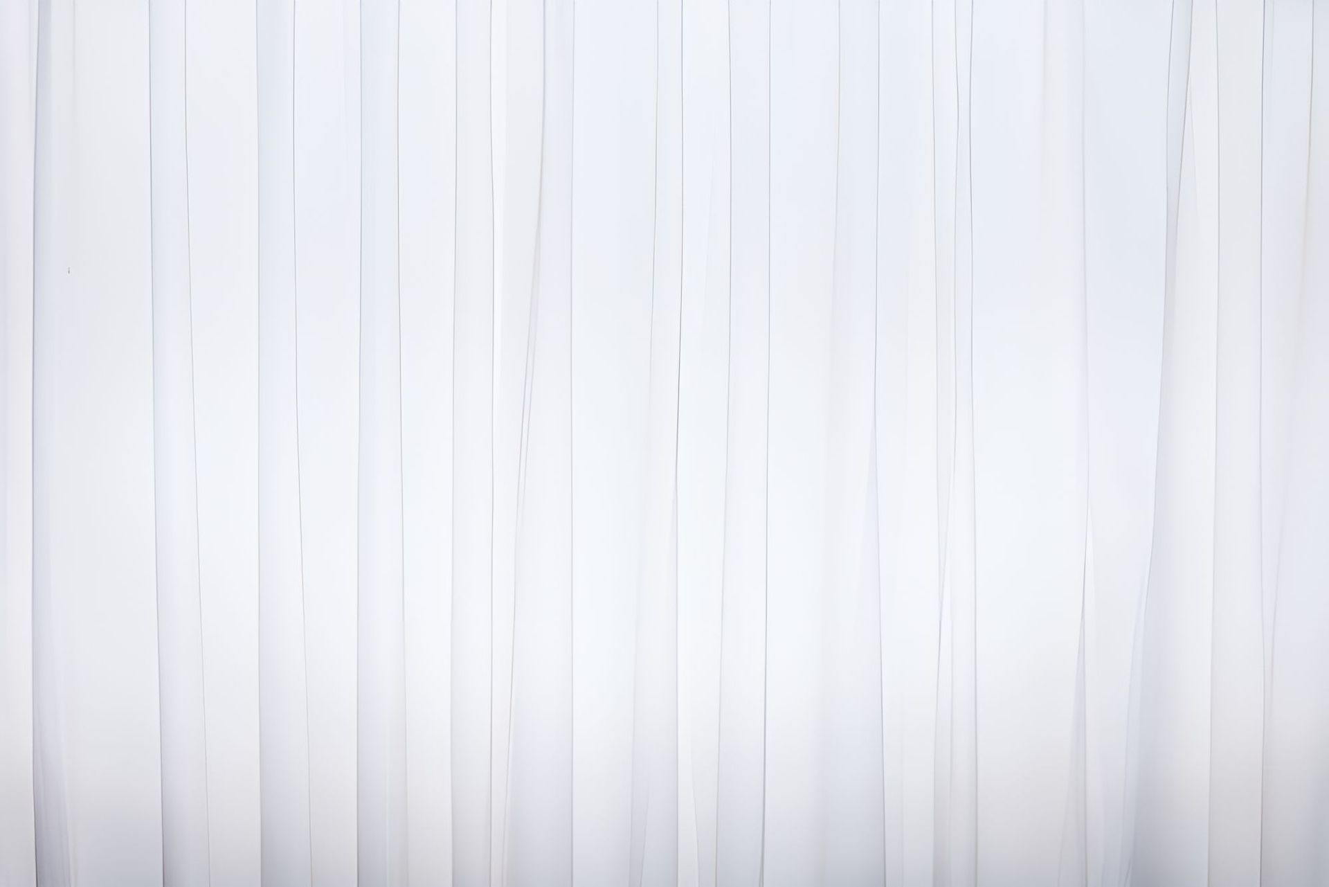 A Close Up of a White Vertical Blind on a Window — Newcastle Curtains And Blinds In Wallsend, NSW