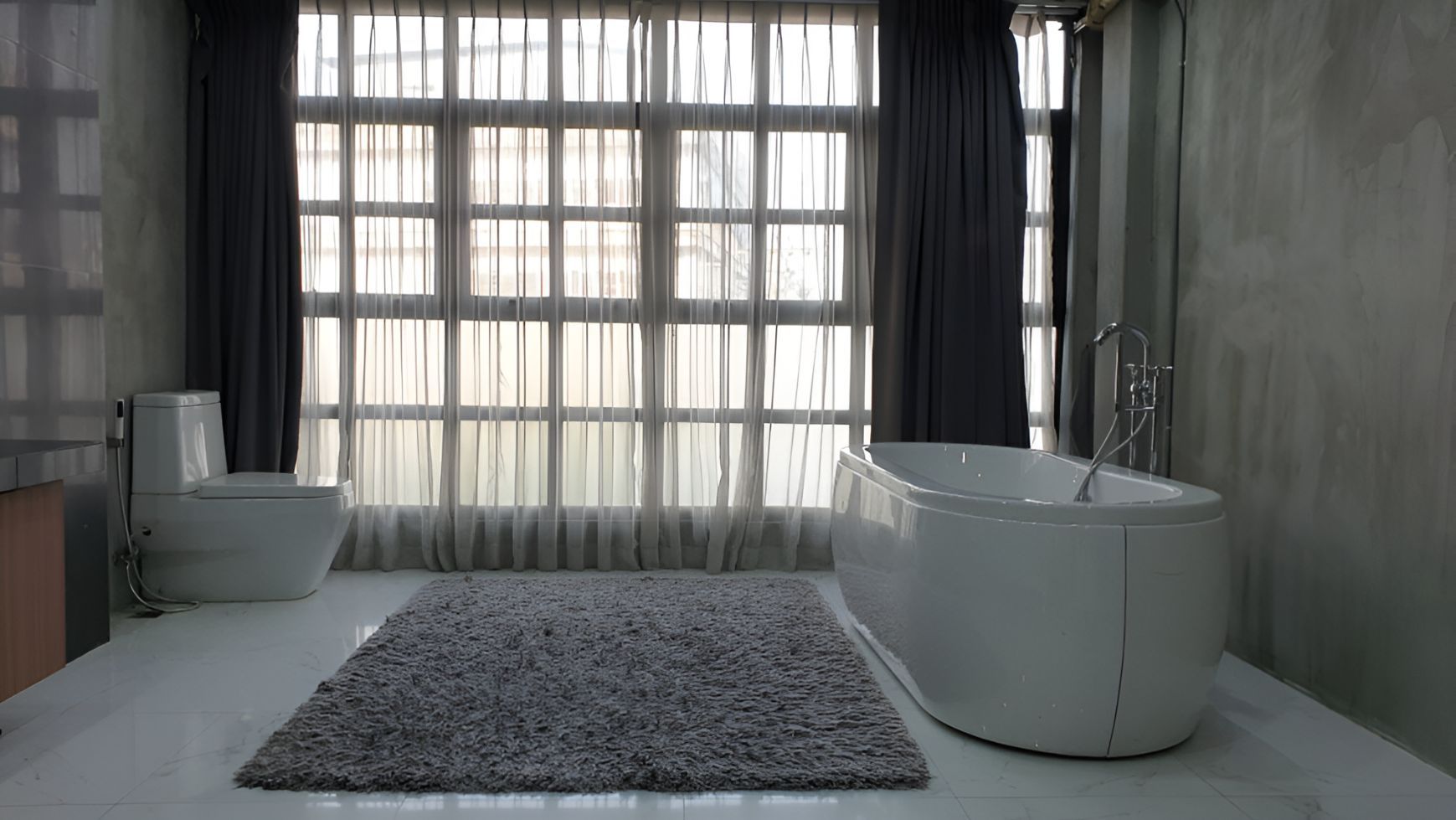 A Bathroom With a Tub, Toilet, and Window — Newcastle Curtains And Blinds In Warners Bay, NSW