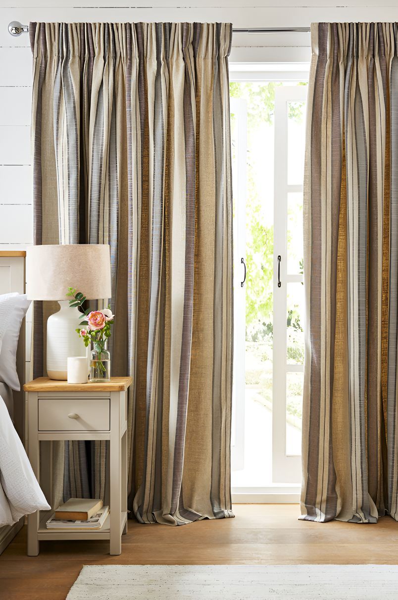A Bedroom With a Bed, Nightstand, Lamp and Curtains — Newcastle Curtains And Blinds In Belmont, NSW