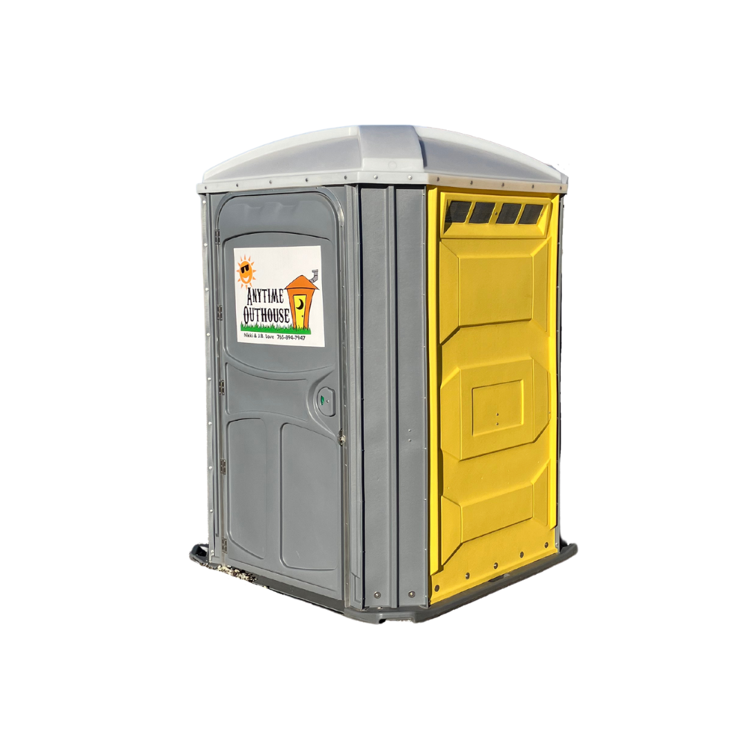 Portable toilet, gray and yellow, outdoors with a curved roof, a door on the left and a yellow panel on the right.