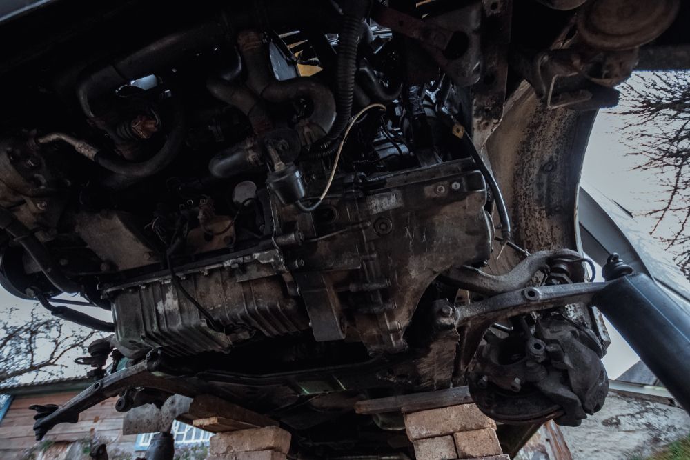 An Engine From a Car Positioned on a Brick Wall — North Queensland Independant Fuel Services in Slade Point, QLD