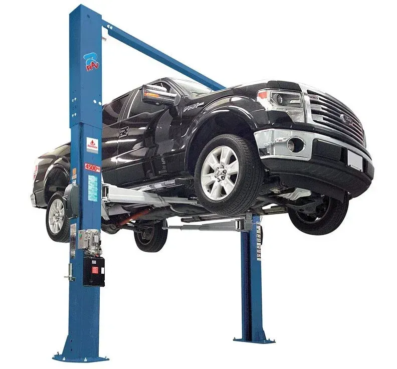 A Black Truck Raised by a Blue Two-post Car Lift — North Queensland Independant Fuel Services in Slade Point, QLD