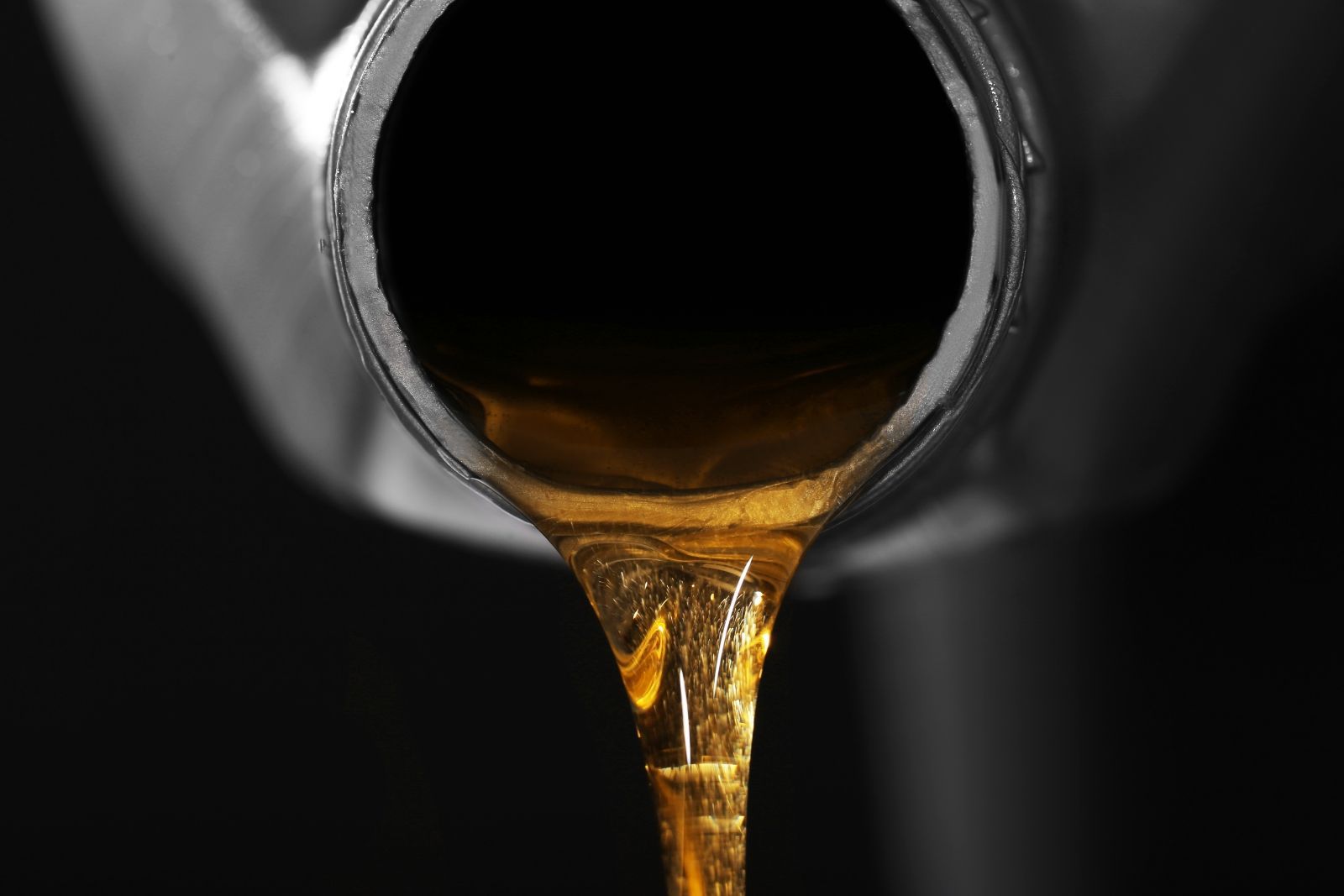 A Close Up of a Person Pouring Oil Into a Bottle — North Queensland Independant Fuel Services in Slade Point, QLD