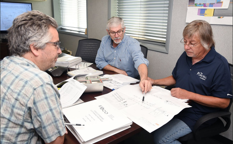 Three men in team meeting