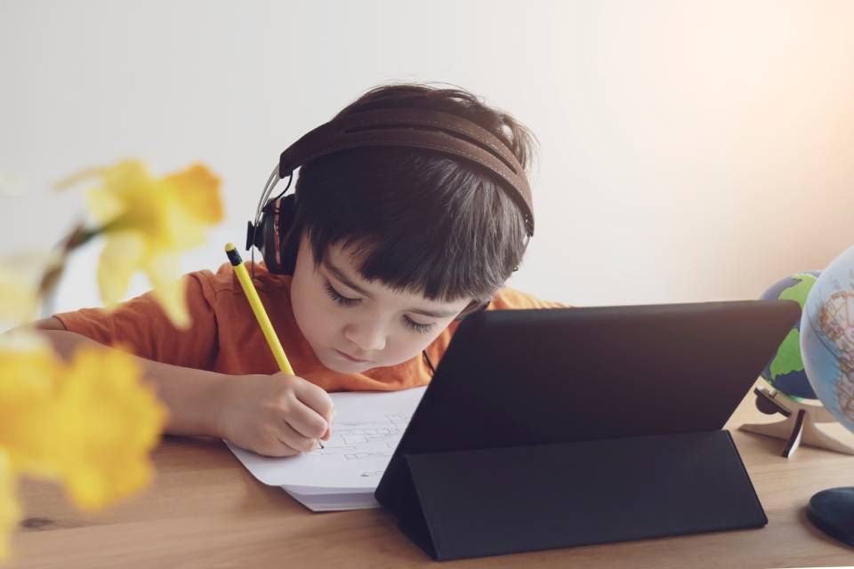 a children learning from tab