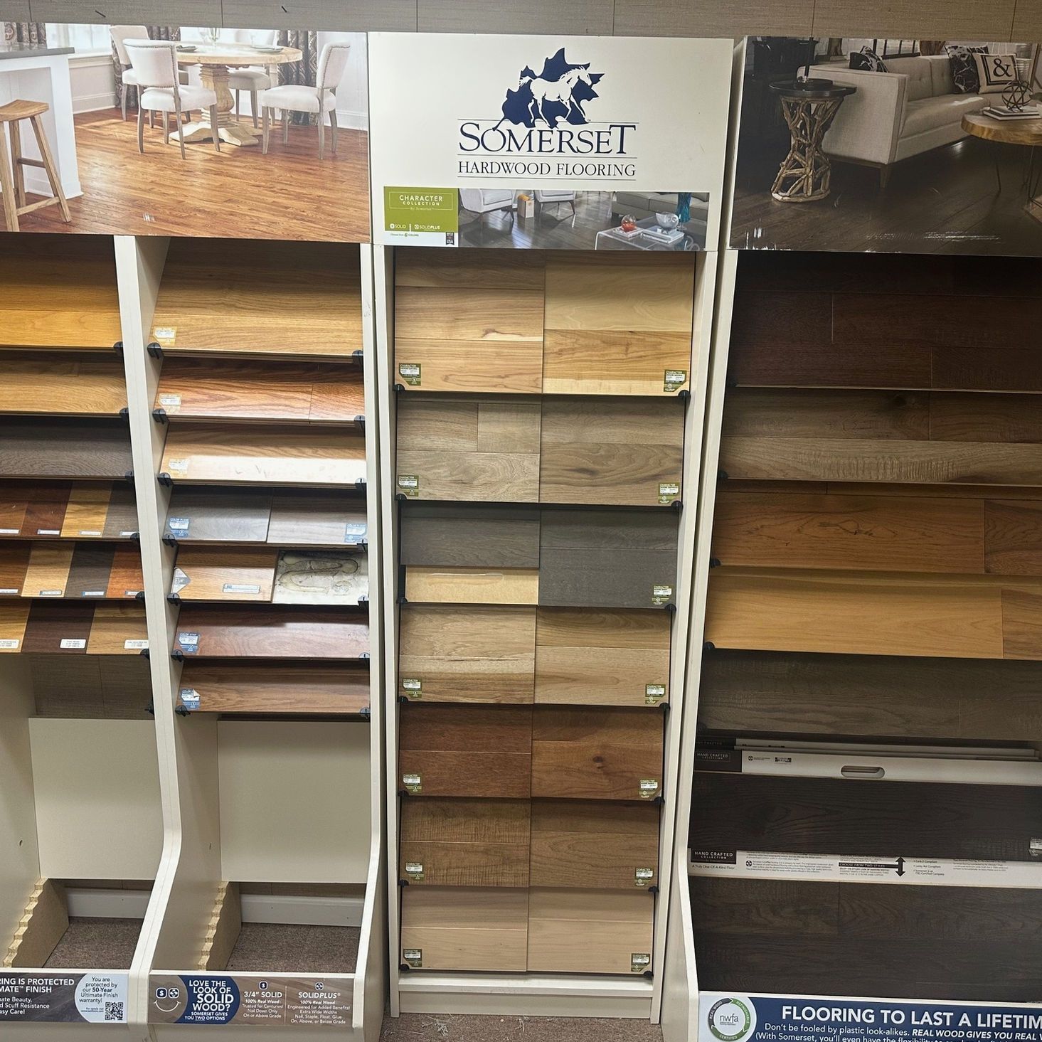 Display of wood flooring samples with various colors and textures.