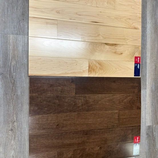 Two wood floor samples: one light, the other dark brown.