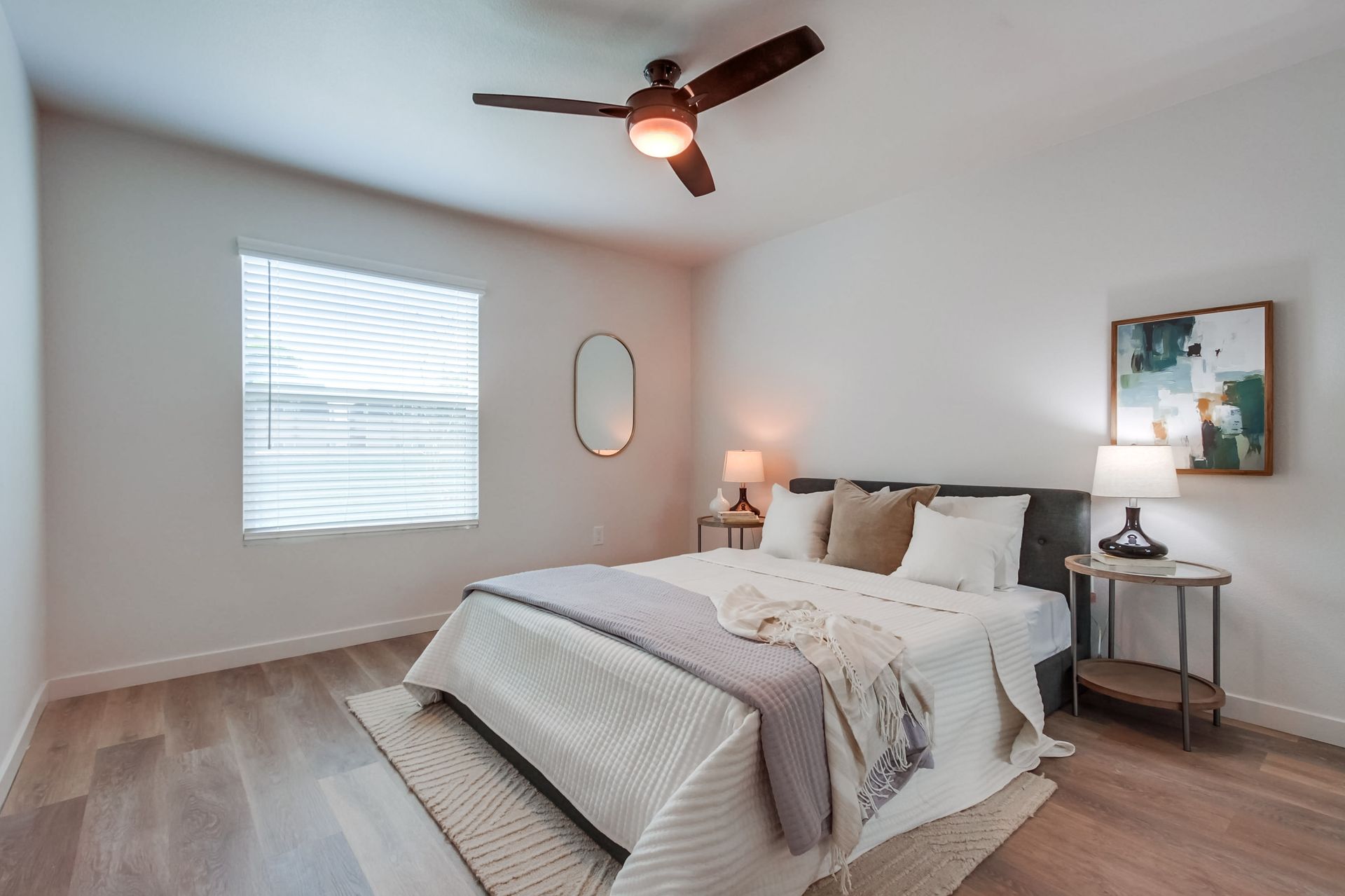 Photo showing a bedroom with a ceiling fan and a wide window
