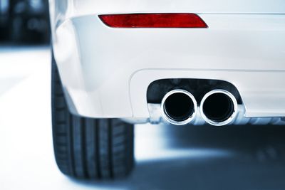 White Car with Muffler — Huntsville, AL — Worth Exhaust Center White Car with Muffler — Huntsville, AL — Worth Exhaust Center