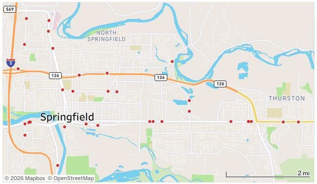 Map of Springfield with roads, river, and red location markers on a city street map