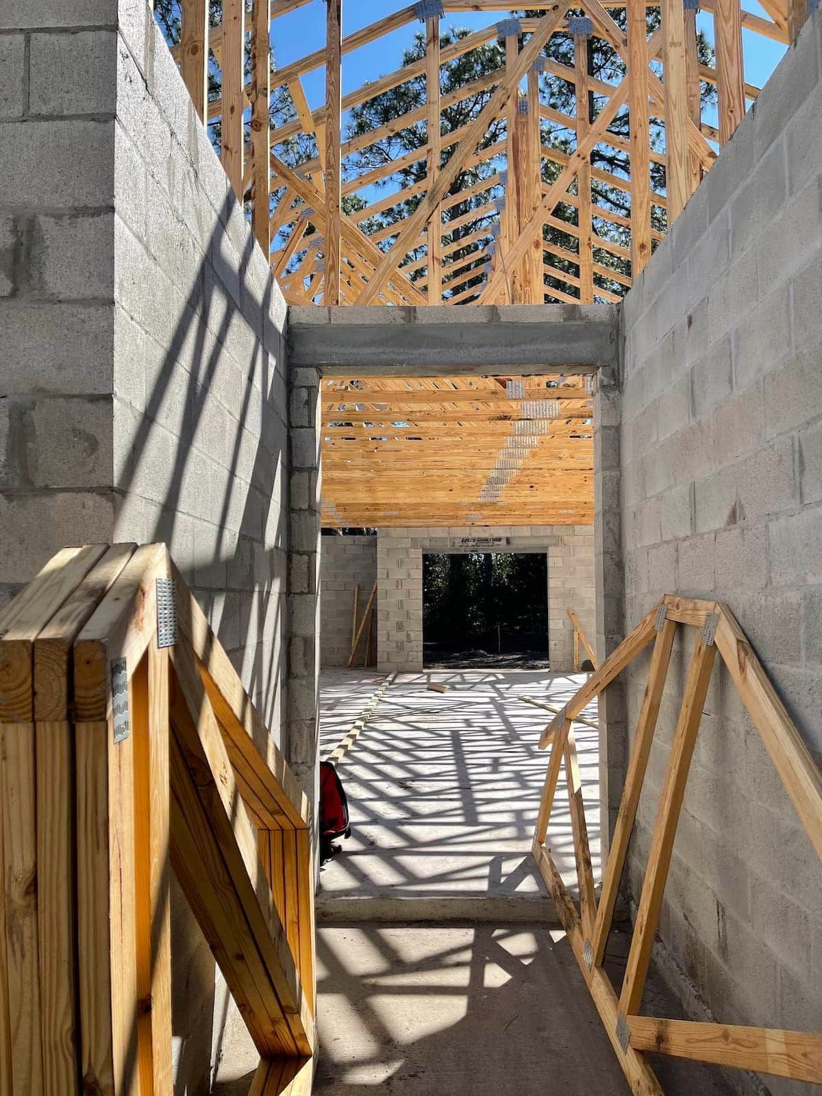 A wooden structure is being built in a building under construction.