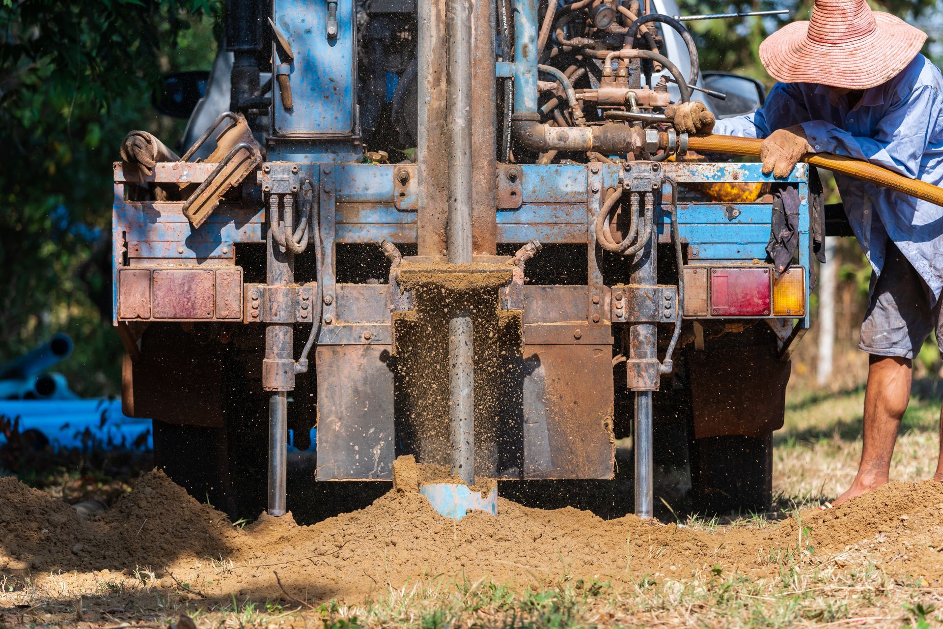 Hydraulic machinery operating at a rural site for professional well abandonment.