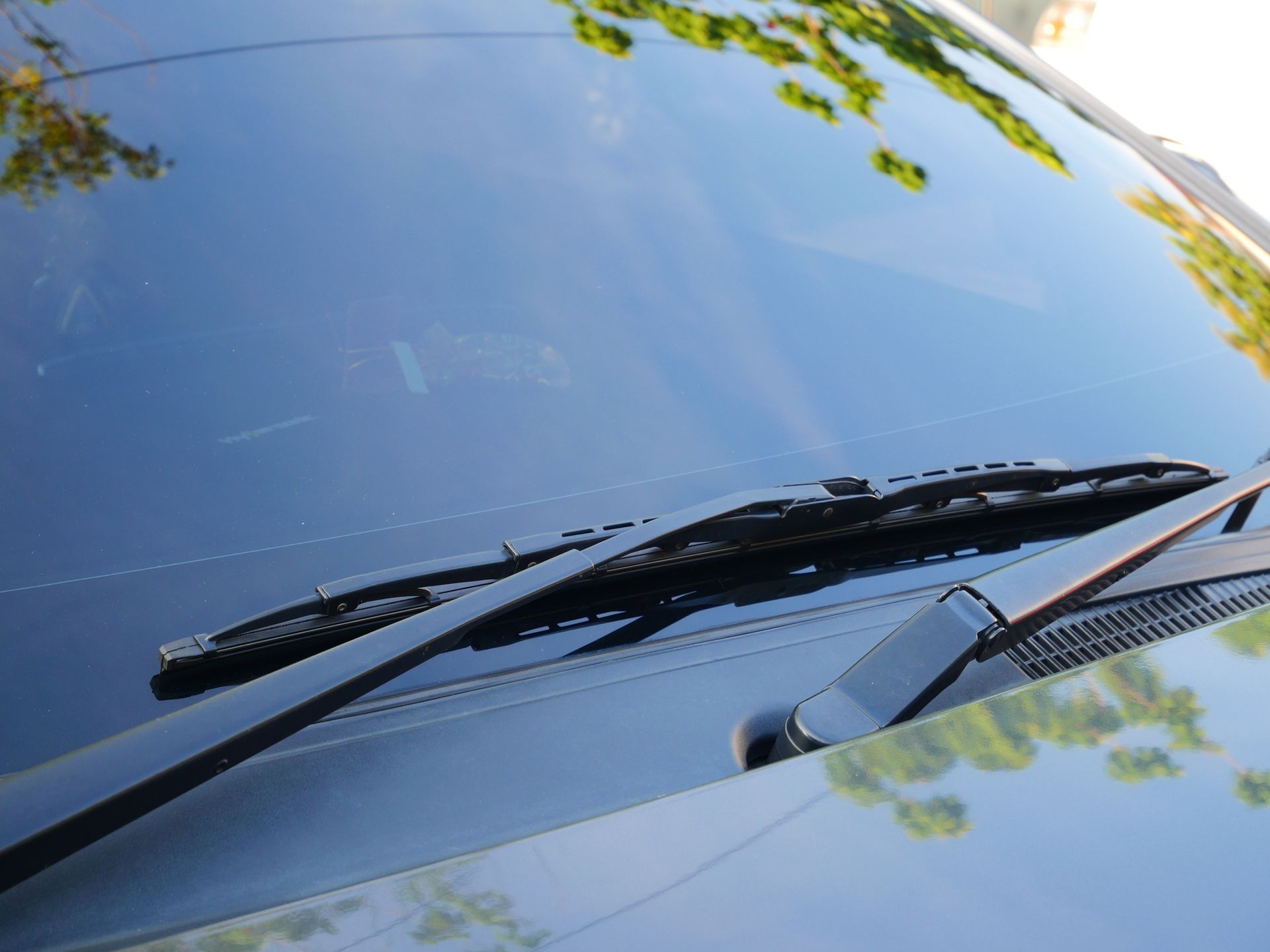 A close up of a windshield wiper on a car