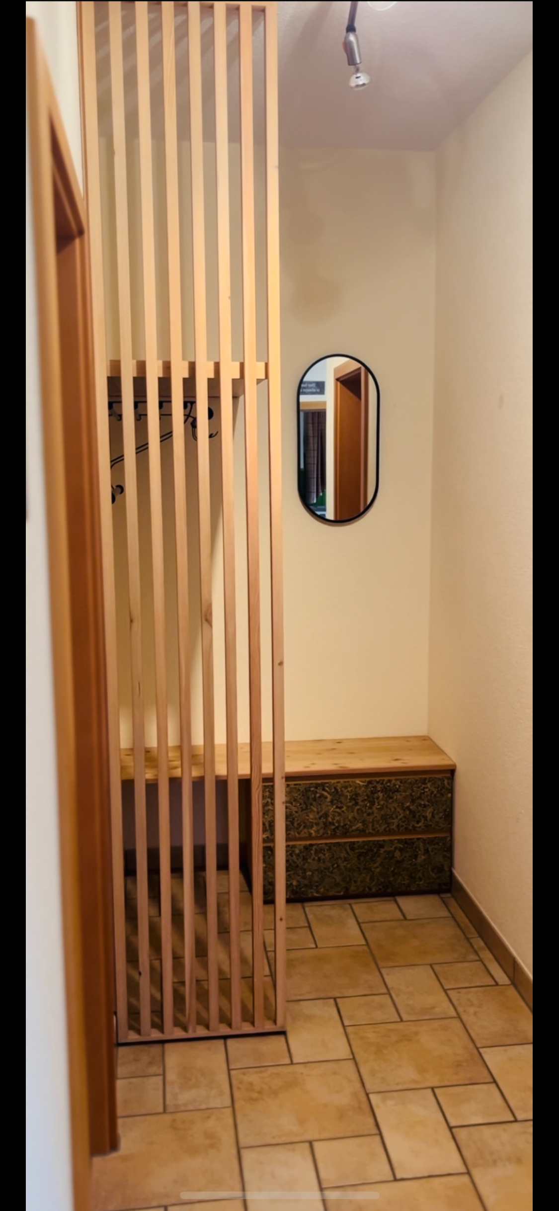 Flurmöbel. Garderobe mit Raumtrenner aus gebürsteter Lärche, geölt. Fronten mit Organoid Oberfläche.