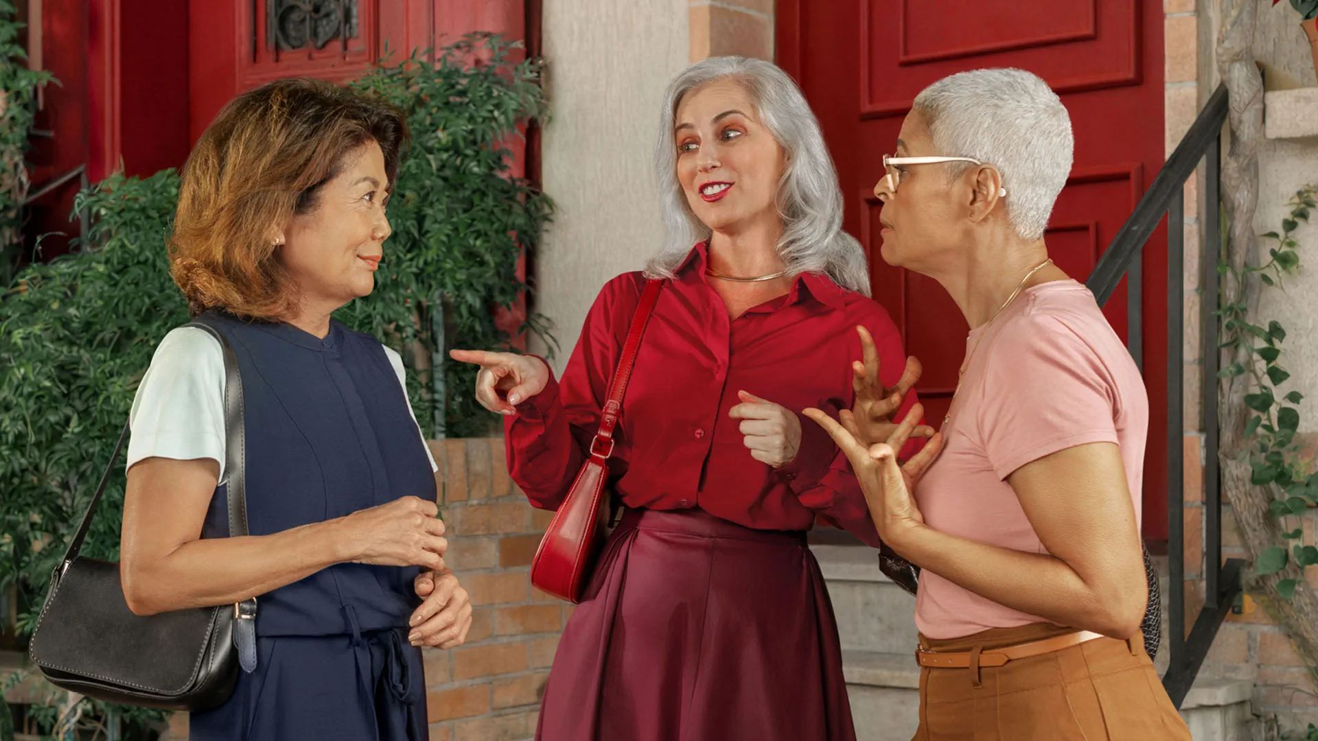 Group of people in conversation, one wearing a Signia MaX hearing aid