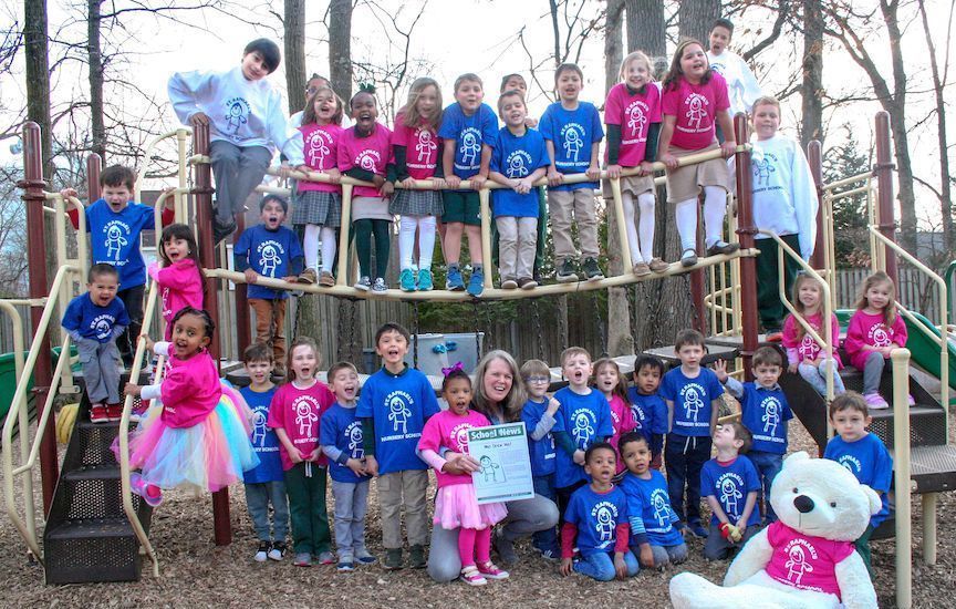 A group of children are posing for a picture at a playground