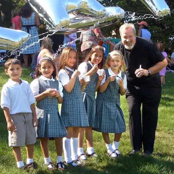 A group of children are posing for a picture on a stage.