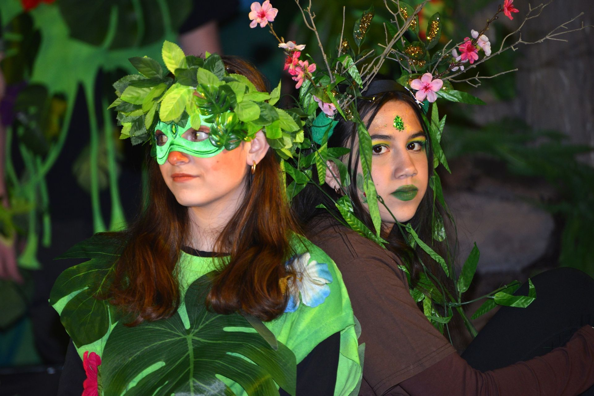 A woman wearing a headband is getting her face painted