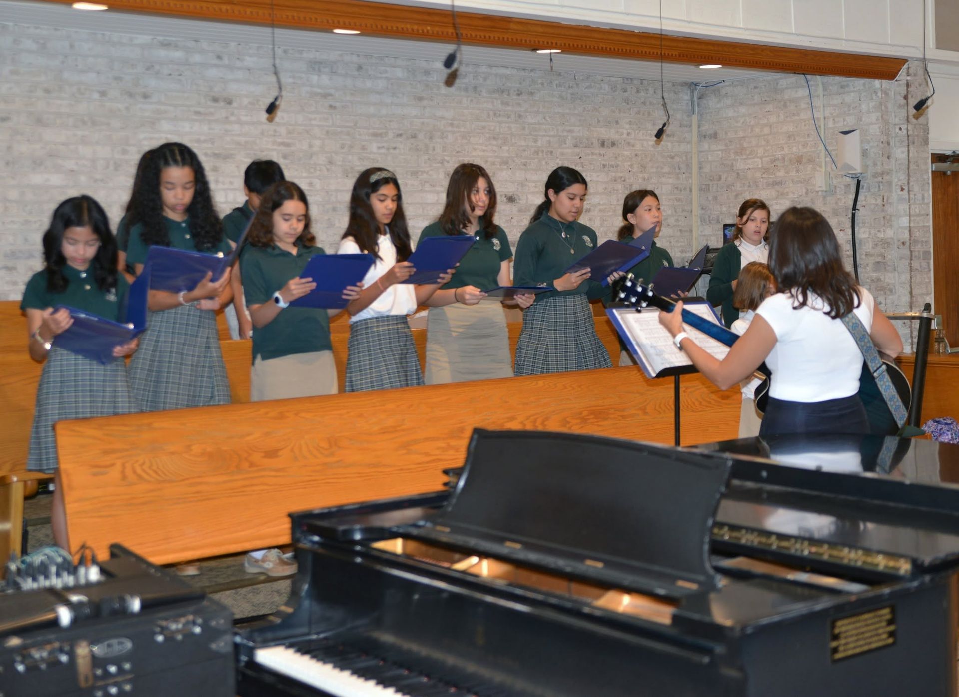 A group of young girls are singing in a choir