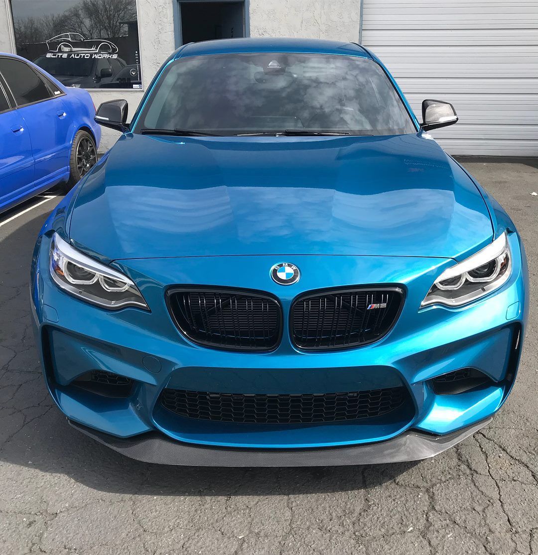 Blue BMW sports car parked outdoors, front view.