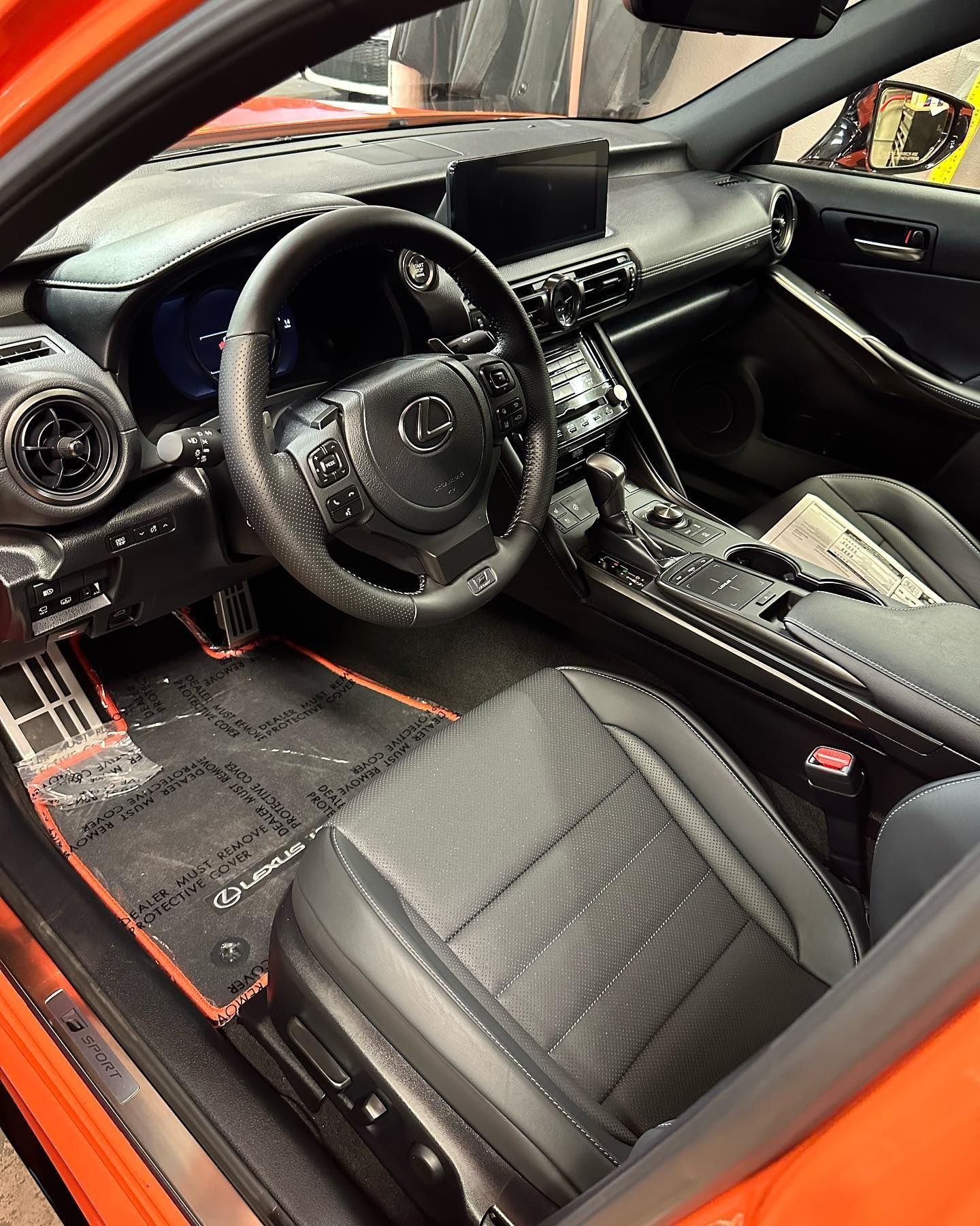 Black Mercedes interior with black leather seats, dashboard, and center console viewed from the driver’s side