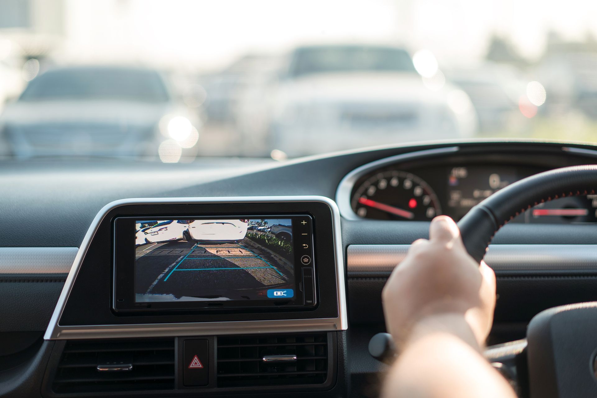 Driver’s view of a car dashboard display showing lane guidance on a road ahead