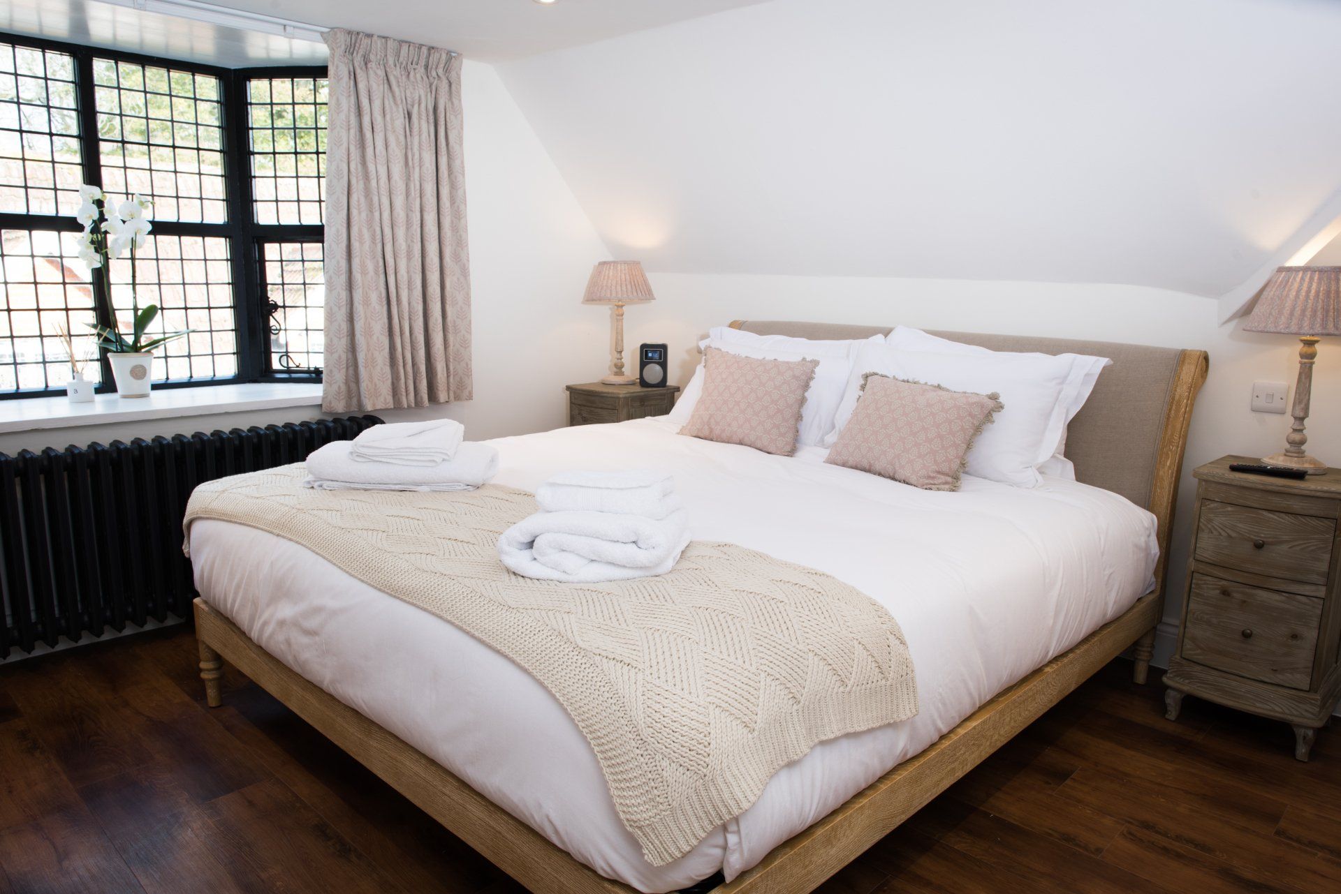 A bedroom with a large bed and a window