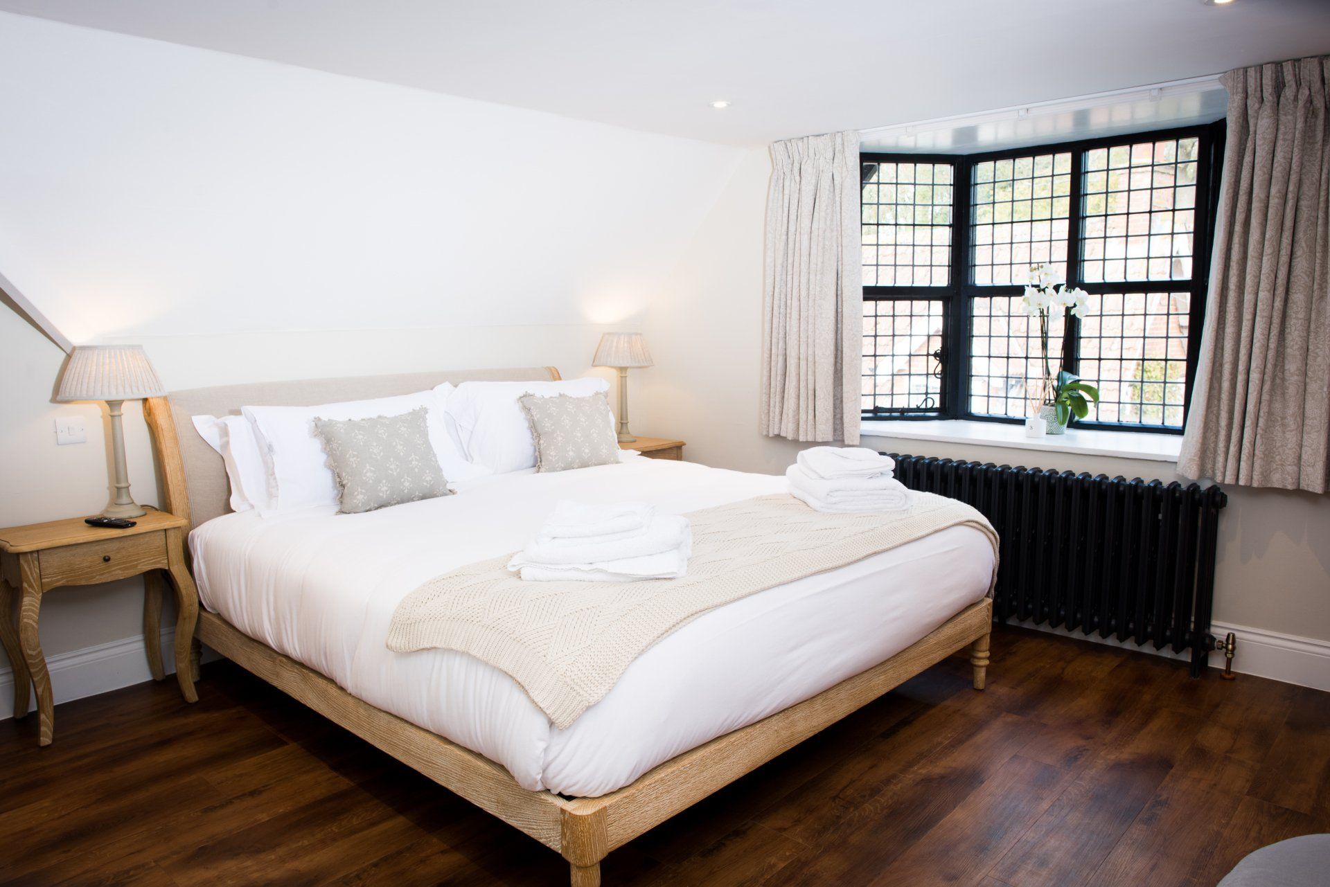 A bedroom with a large bed and a window