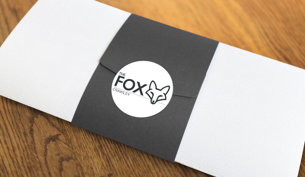 A black and white envelope with the word fox on it