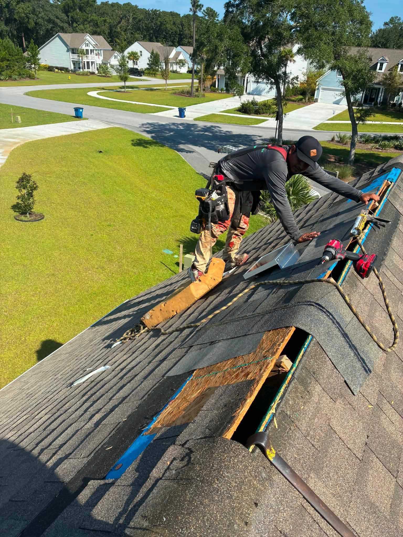 A Charleston homeowner comparing roofing estimates at a kitchen table while a Charleston Roofs and Windows inspection manager shows close-up photos of a cracked pipe boot and lifted shingles on a tablet. The image represents honest roofing estimates in Charleston SC, where the roofer checks the attic and the roof, explains repair versus replacement, and puts a named W2 project manager on the job instead of handing it to an unknown subcontractor crew.