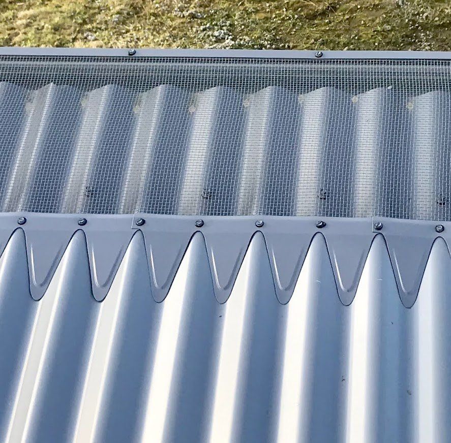 A close up of a metal roof with a mesh covering
