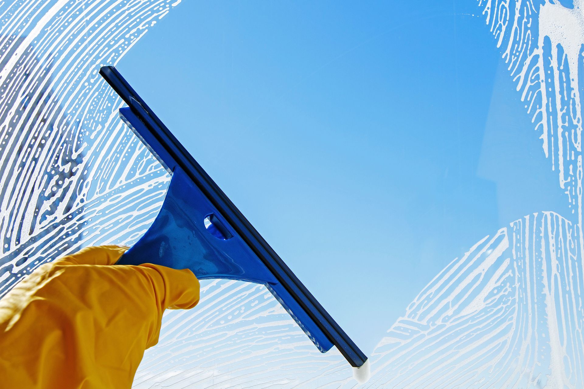 A worker doing window cleaning in McKinney, TX