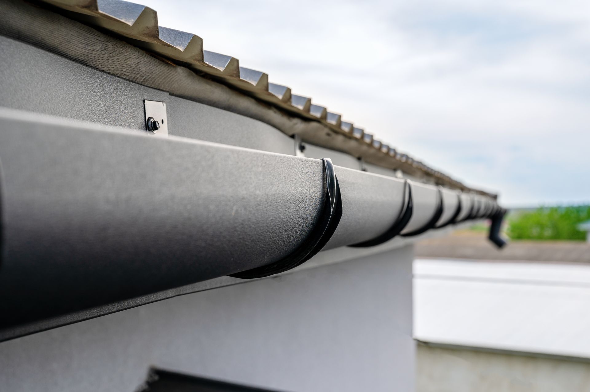 Close-up view of a roof gutter along the edge of a roof.