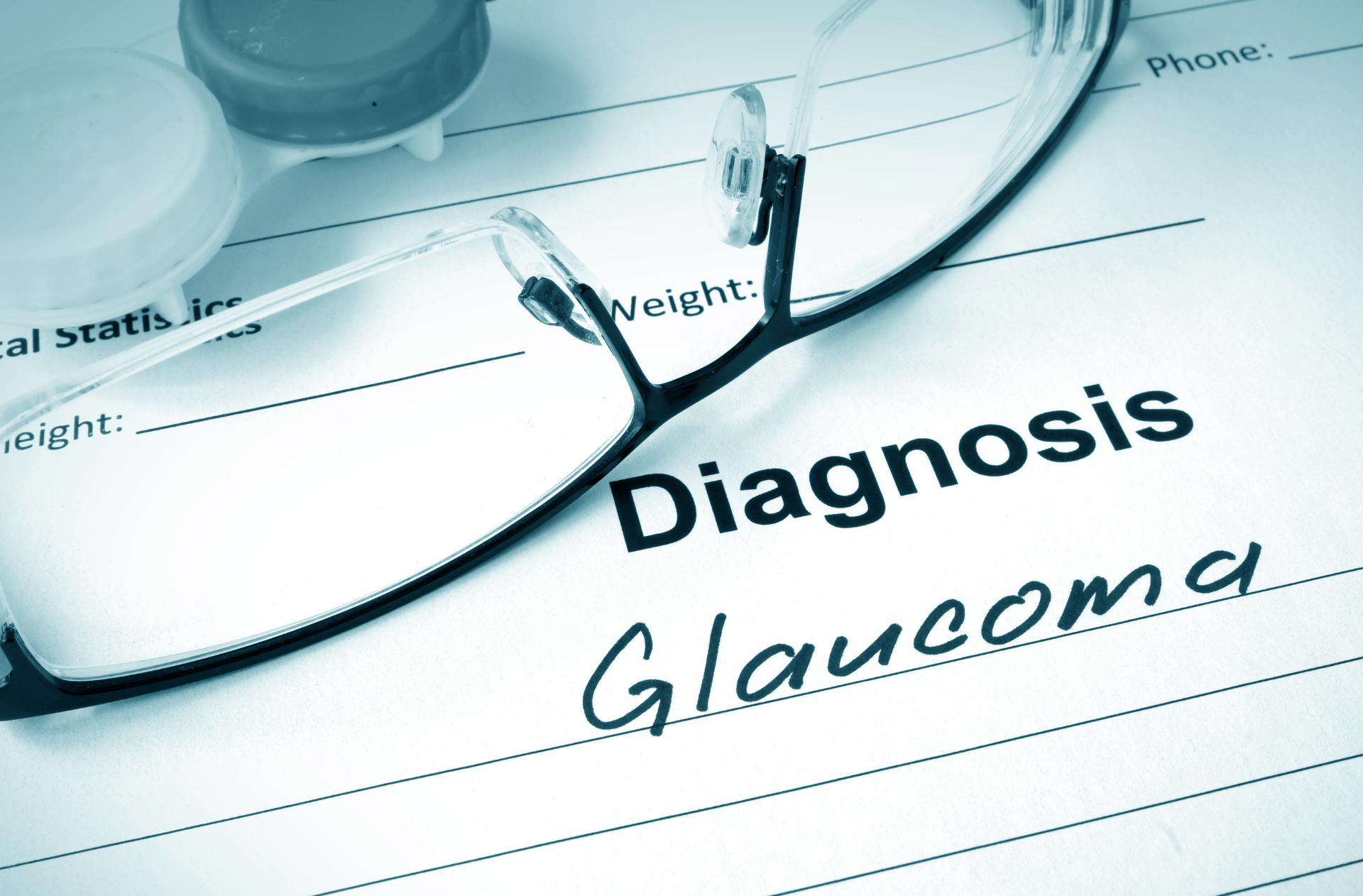 Glasses over a medical form labeled “Diagnosis” and “Glaucoma”