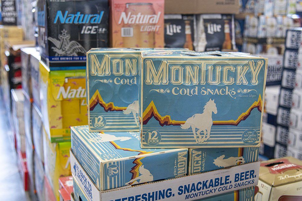 Stacks of beer cases at a store. 