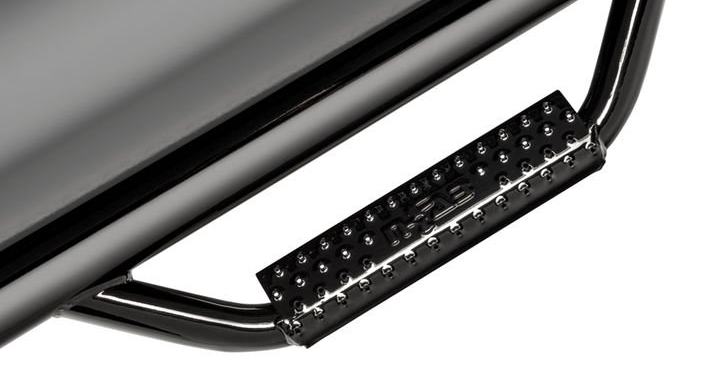 Black metal side step attached to a vehicle's body, with a textured step surface.