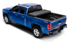 Blue Chevy Silverado pickup truck with a black Extang cover partially open.