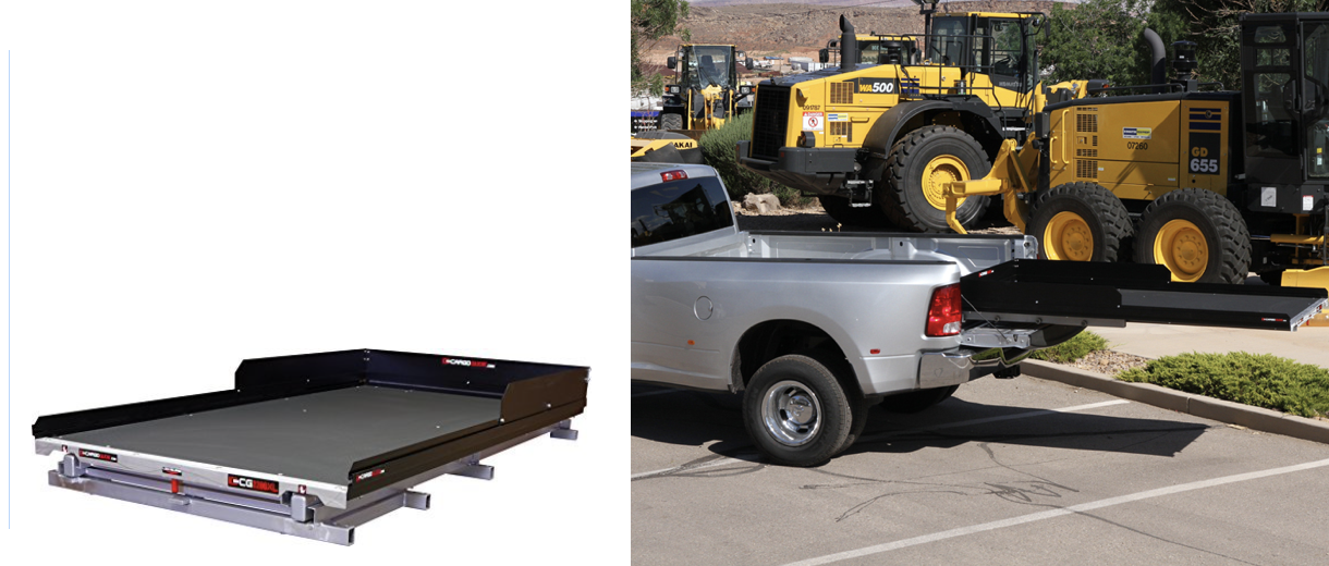 A truck bed extender with heavy machinery loaded on the truck.