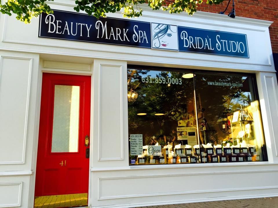 Beauty Mark Spa and Bridal Studio storefront with a bright red door and a large display window featuring salon products.
