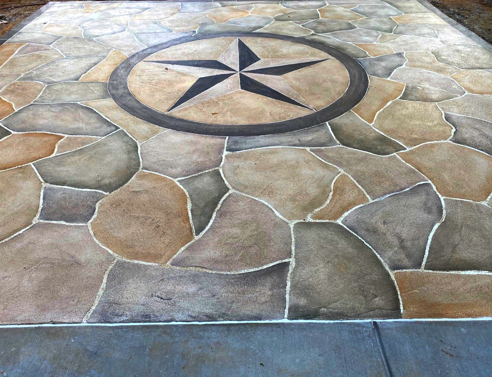 Stone courtyard with a compass rose mosaic set in tan and gray paving tiles