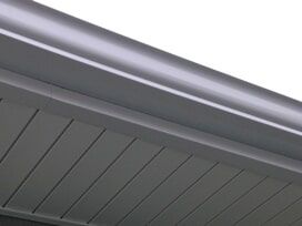 Gray gutters and soffit on a building's edge.