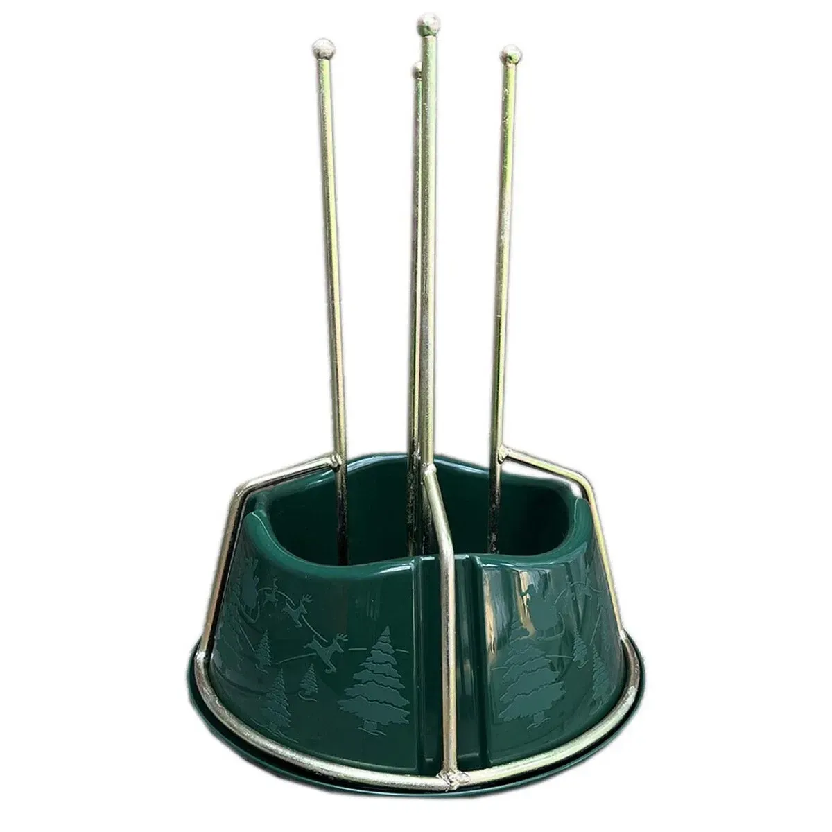 Gold metal Christmas tree stand with a green decorative plastic water container.