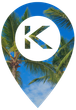 A map pin icon with a white background and the letter "K" in the center, overlaid on a blue sky with palm tree leaves.