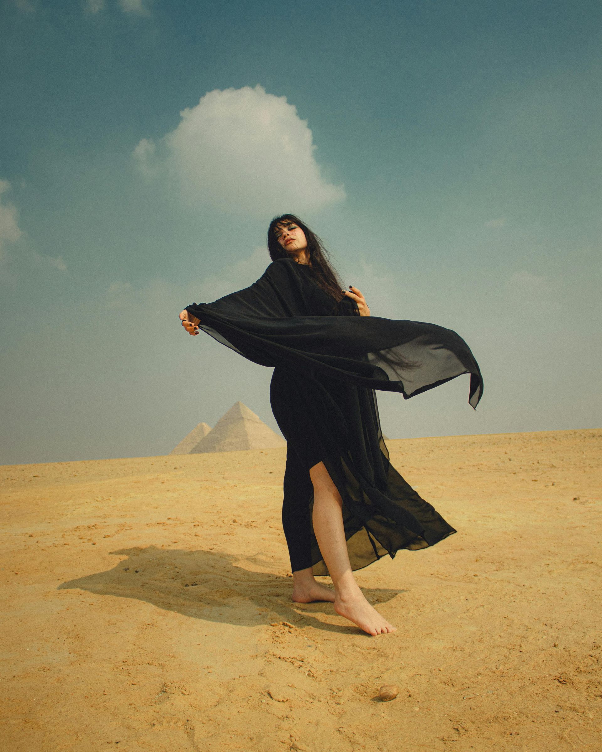 Woman enjoying the desert atmosphere near the Pyramids of Giza in Egypt