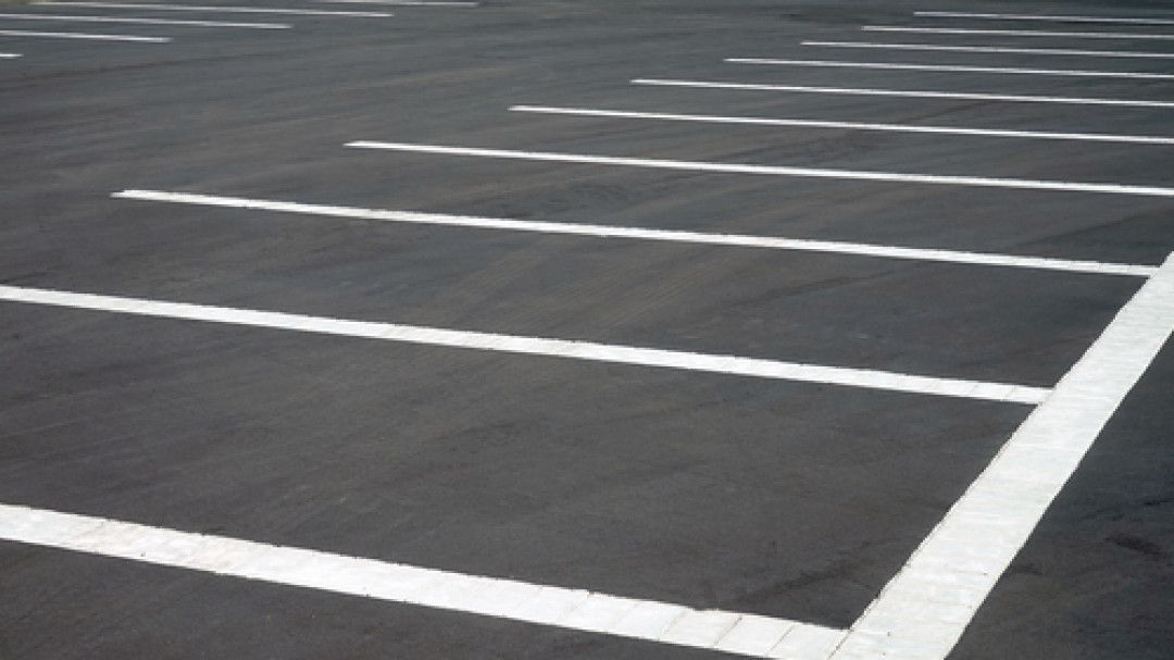 A parking lot with white lines on the asphalt