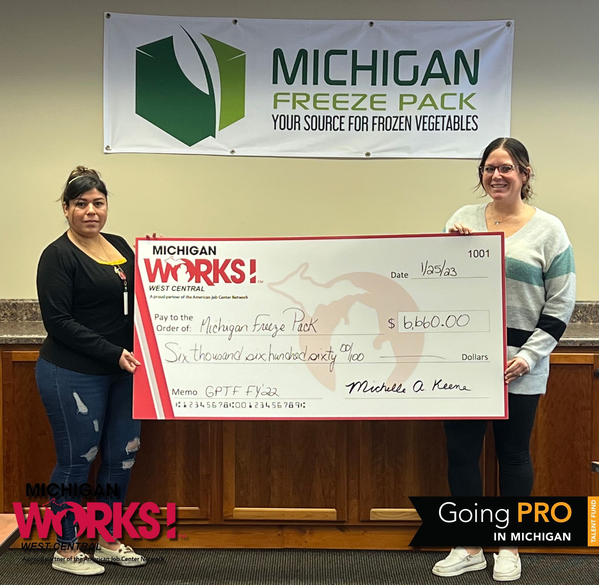 Representative from Michigan Freeze Pack accept a check for completing their FY22 Going PRO Talent Fund training plan.