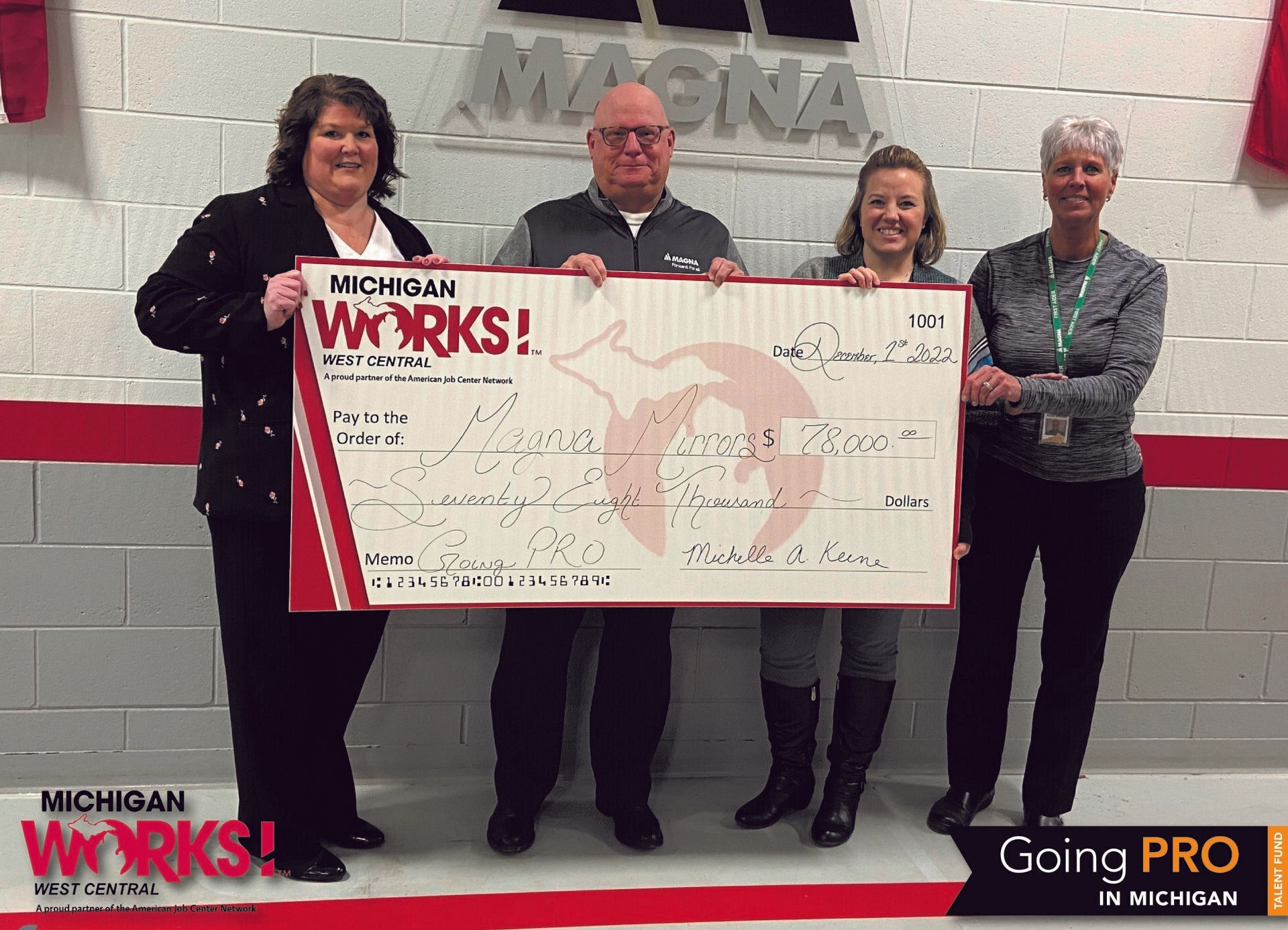 Michigan Works! West Central Executive Director Shelly Keene (left) presents a check to the leadership team at Magna Mirrors Newaygo  Division, (from left to right) Daniel Groszkiewicz, Leslie Crum and Lavonne Hysell.