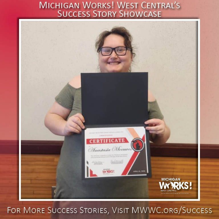Woman holding a certificate and black folder, smiling in front of a West Central’s Success Story Showcase backdrop