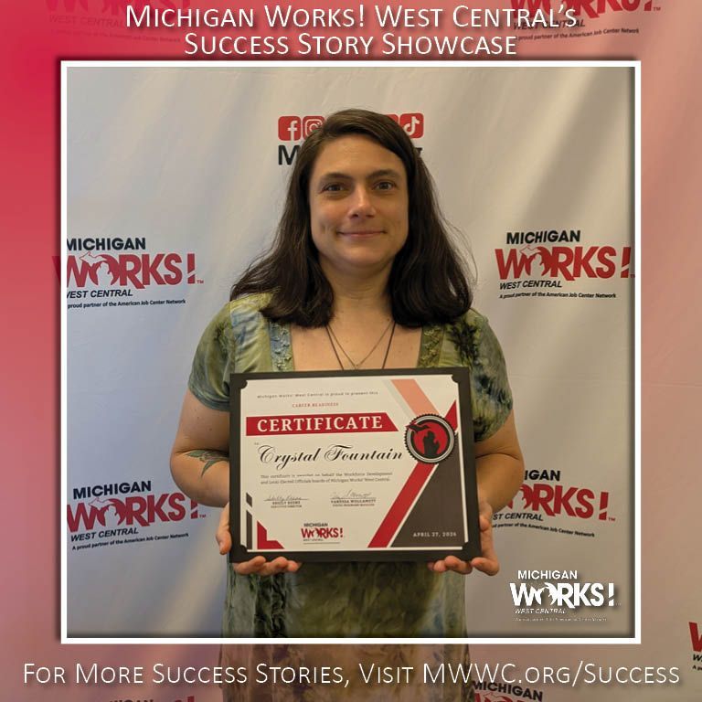 Woman holding a certificate in front of a Michigan Works! Success Story Showcase backdrop